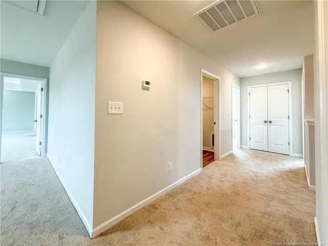a spacious bathroom with a granite countertop sink and a mirror