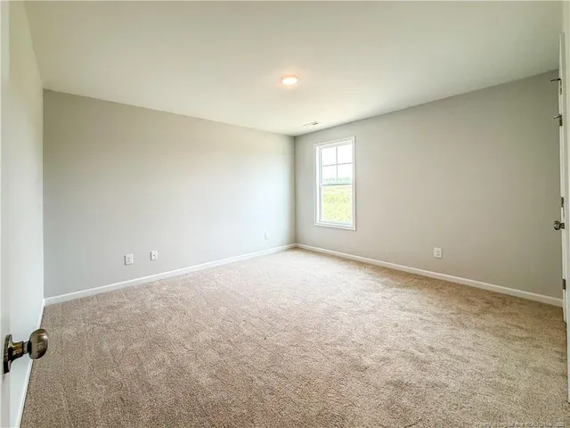 an empty room with a empty space and windows