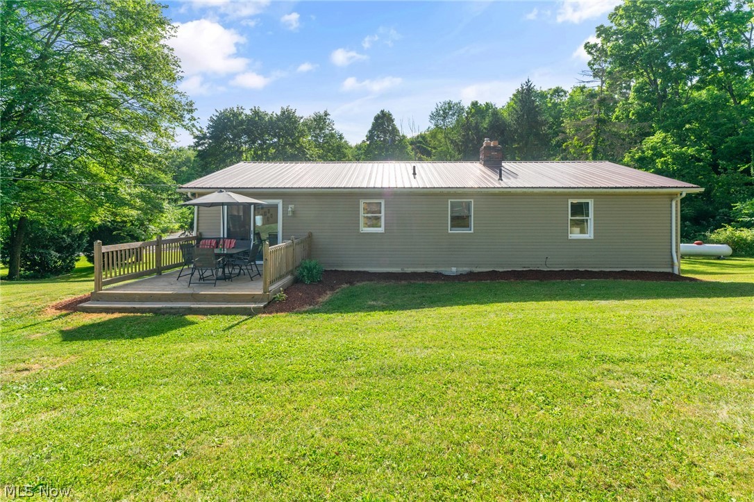 8184 Rochester Road East Rochester, OH 44625 - Photo 22 of 28 Back of property featuring a yard and a wooden deck