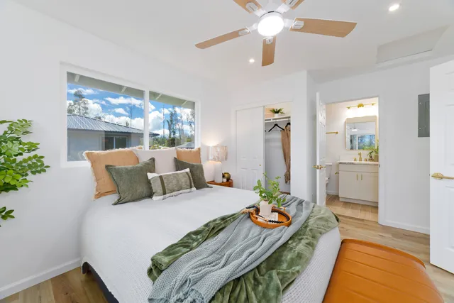 a bed room with a bed and a chandelier