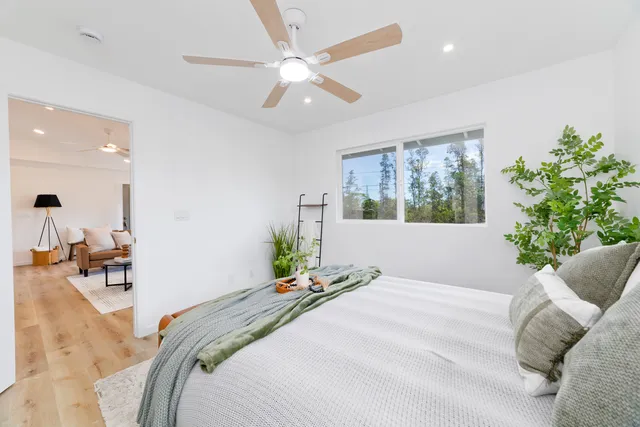 a bedroom with a large bed and a chandelier
