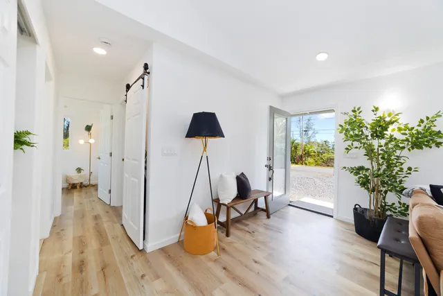 a view of a workspace with furniture and a potted plant