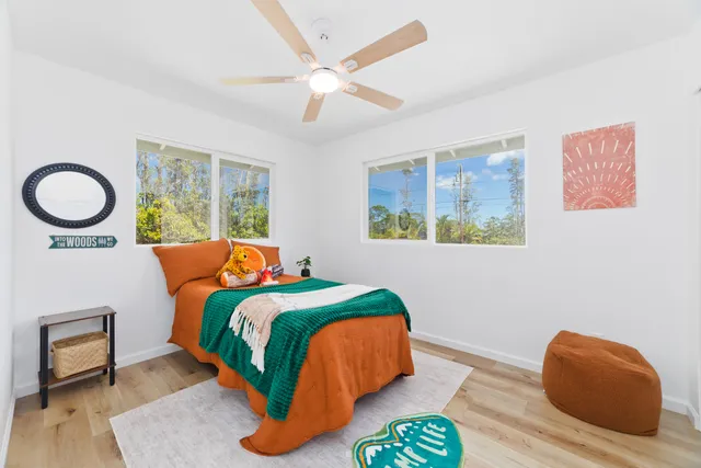 a bedroom with a bed and a chair