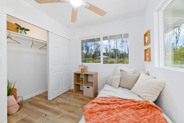 a bedroom with a bed and a window