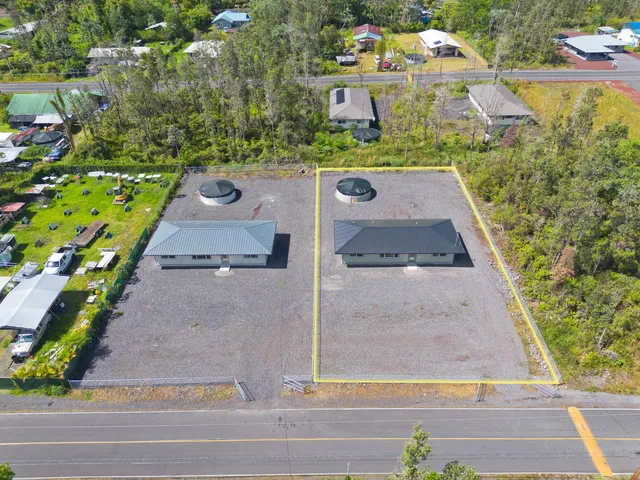 a view of a brick house with a yard