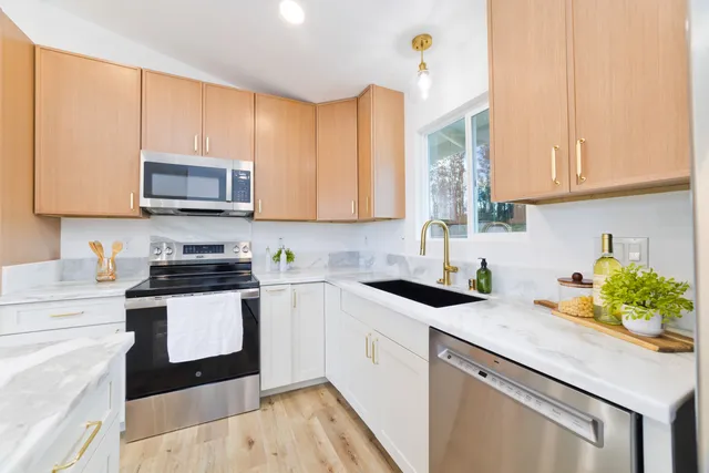 a kitchen with stainless steel appliances granite countertop a sink and cabinets