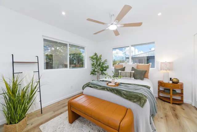 a bedroom with a bed and a chandelier