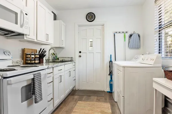 a utility room with cabinets washer and dryer