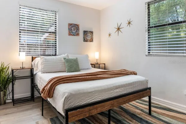 a bedroom with a bed and a window