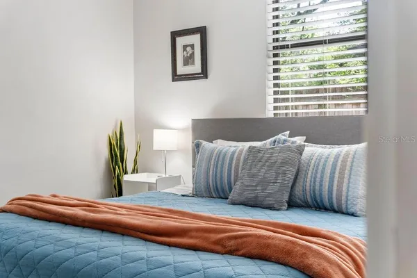a bedroom with a bed and a window