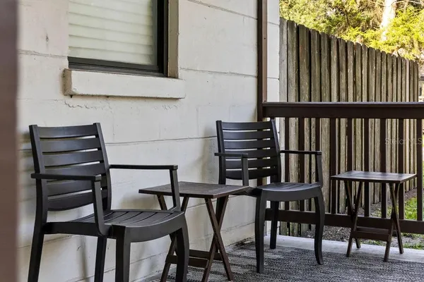 a view of a chairs and table in the balcony