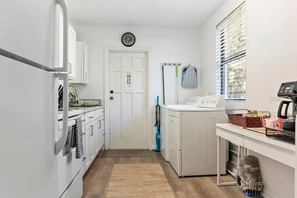 a utility room with cabinets washer and dryer