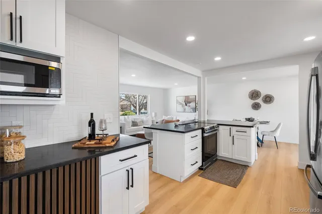 a kitchen with a sink stove and cabinets