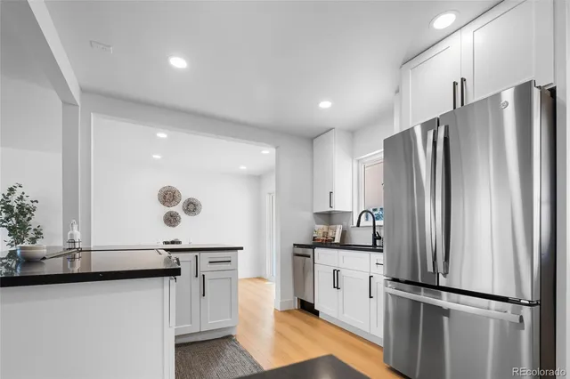 a kitchen with stainless steel appliances a refrigerator and a sink
