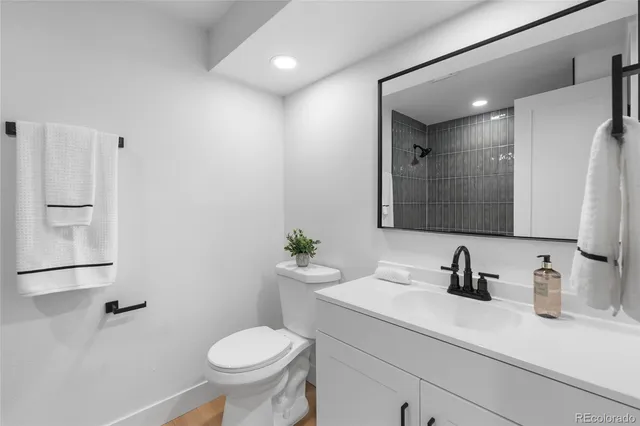 a bathroom with a sink toilet and a mirror