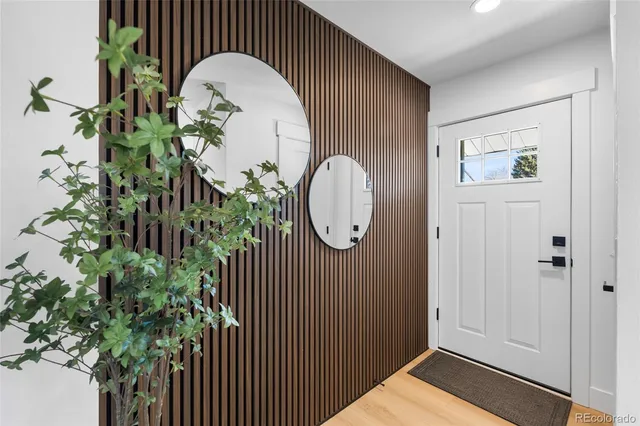 an entryway with wooden floor