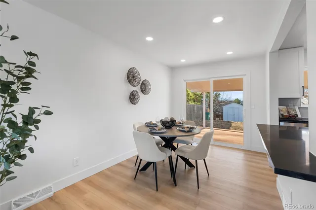 a view of a dining room with furniture window and wooden floor