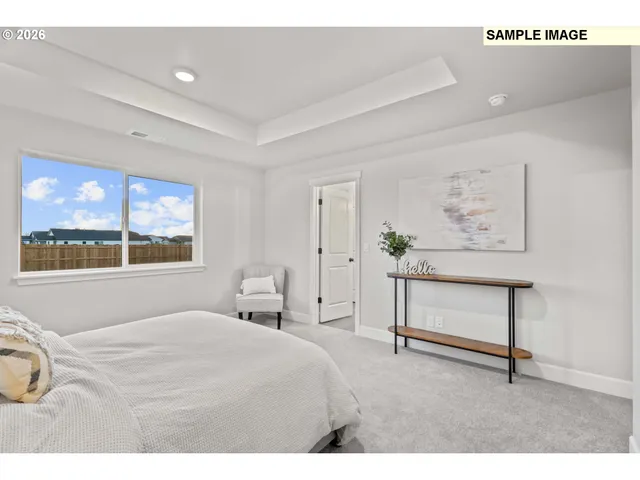 a bedroom with a bed and a painting on the wall