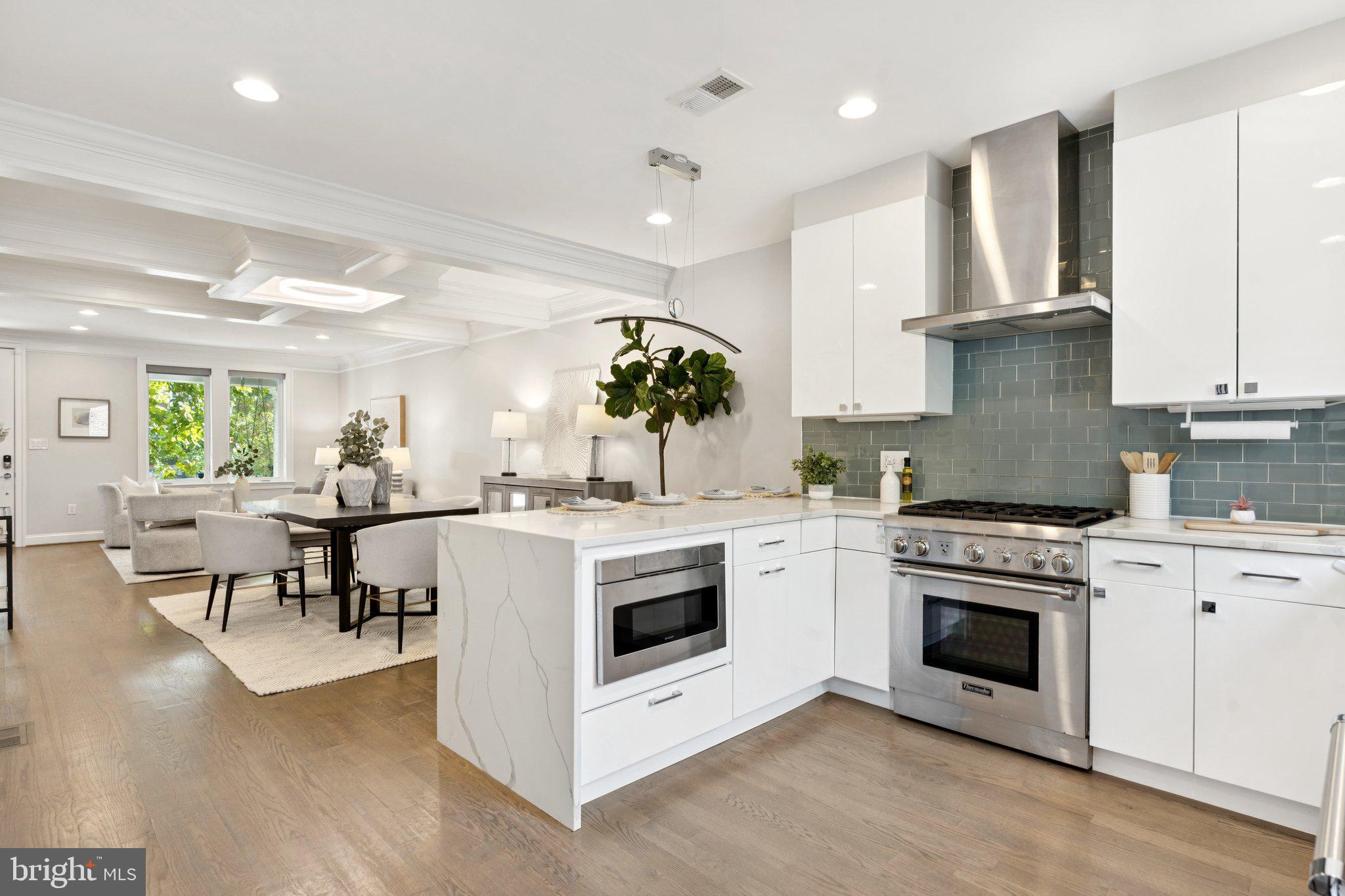929 Quincy Street Northwest Washington, DC 20011 - Photo 12 of 37 a kitchen with a stove top oven and cabinets