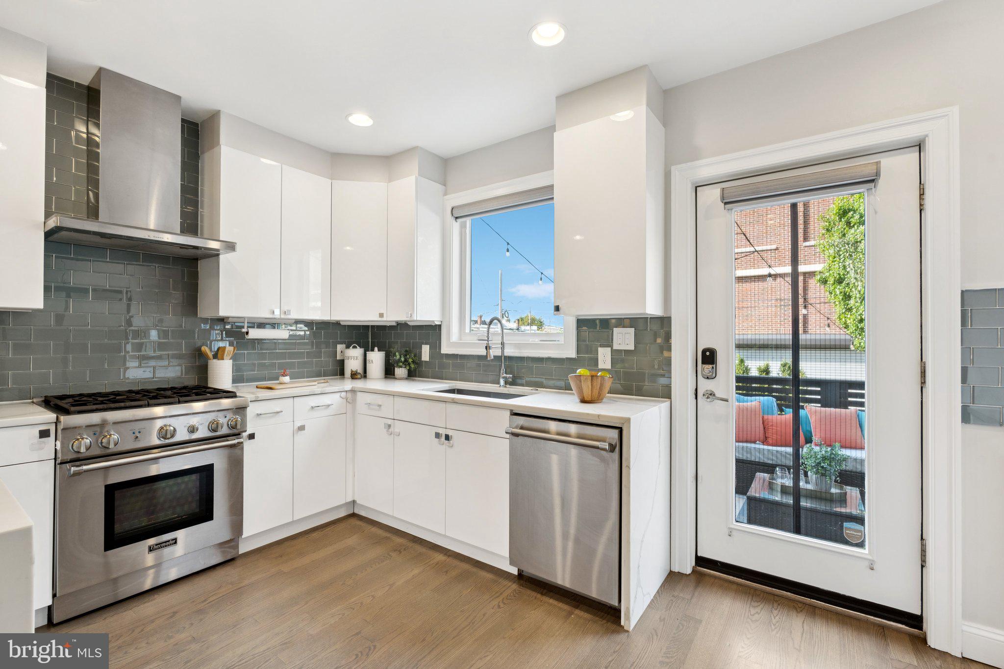 929 Quincy Street Northwest Washington, DC 20011 - Photo 13 of 37 a kitchen with stainless steel appliances granite countertop a stove and a refrigerator
