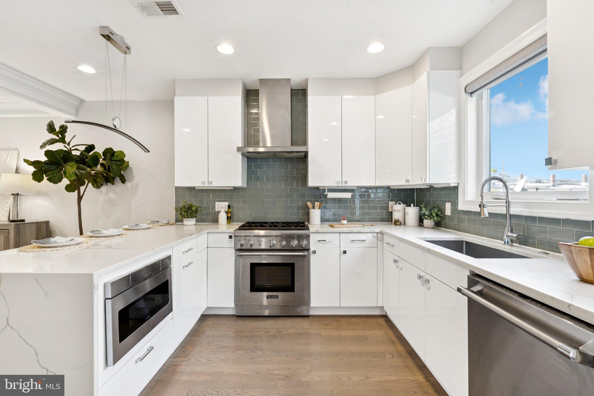 929 Quincy Street Northwest Washington, DC 20011 - Photo 14 of 37 a kitchen with a sink stove and cabinets