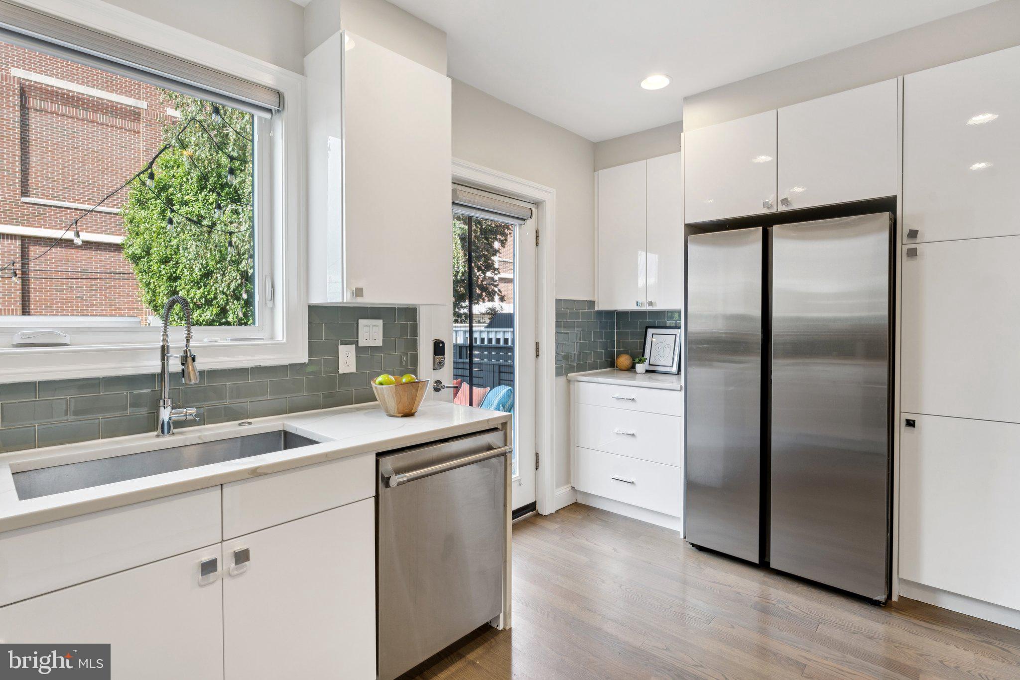 929 Quincy Street Northwest Washington, DC 20011 - Photo 15 of 37 a kitchen with white cabinets and a refrigerator