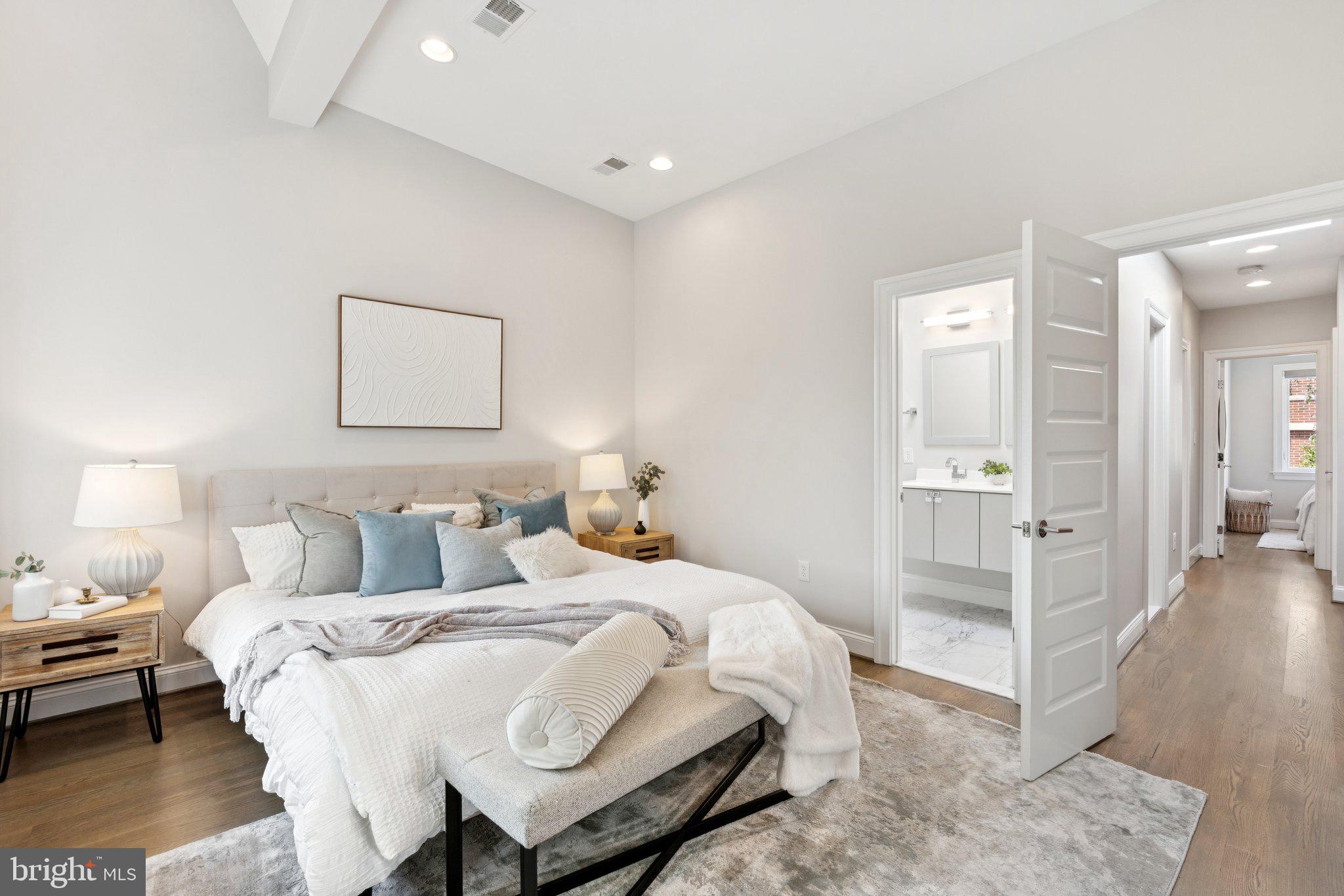 929 Quincy Street Northwest Washington, DC 20011 - Photo 18 of 37 a bedroom with a bed and a view of bathroom