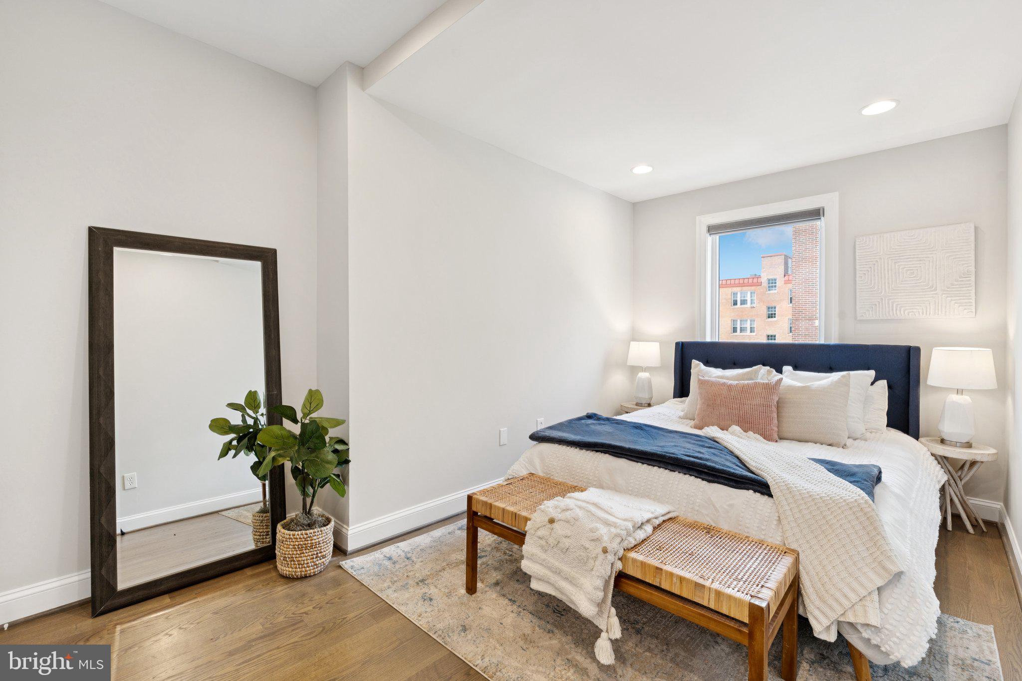 929 Quincy Street Northwest Washington, DC 20011 - Photo 20 of 37 a bedroom with a bed and a potted plant