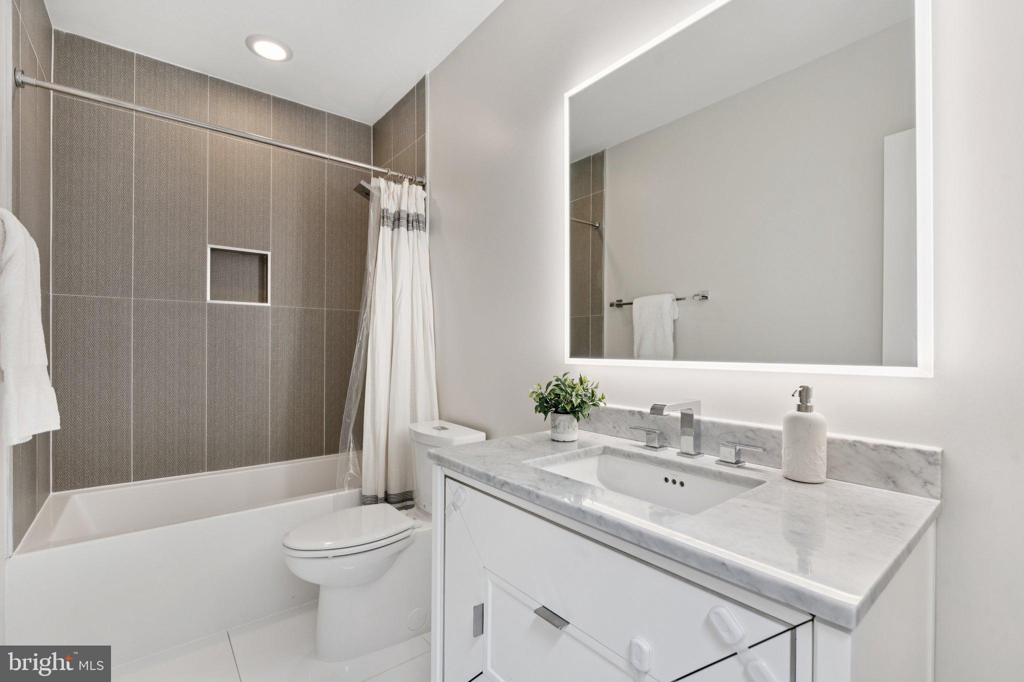 929 Quincy Street Northwest Washington, DC 20011 - Photo 21 of 37 a bathroom with a sink toilet vanity tub and shower