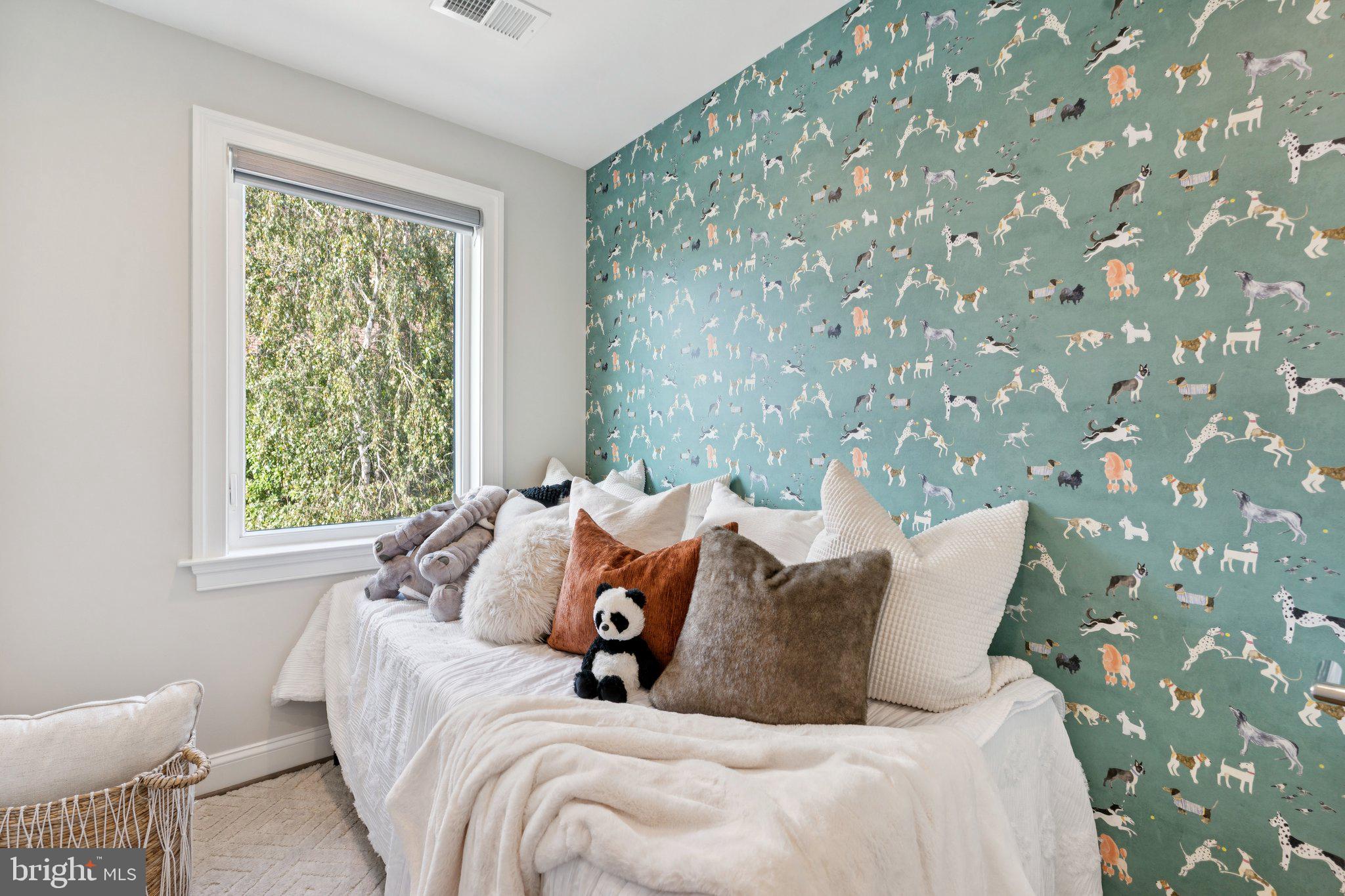 929 Quincy Street Northwest Washington, DC 20011 - Photo 22 of 37 a bed sitting in a bedroom next to a window