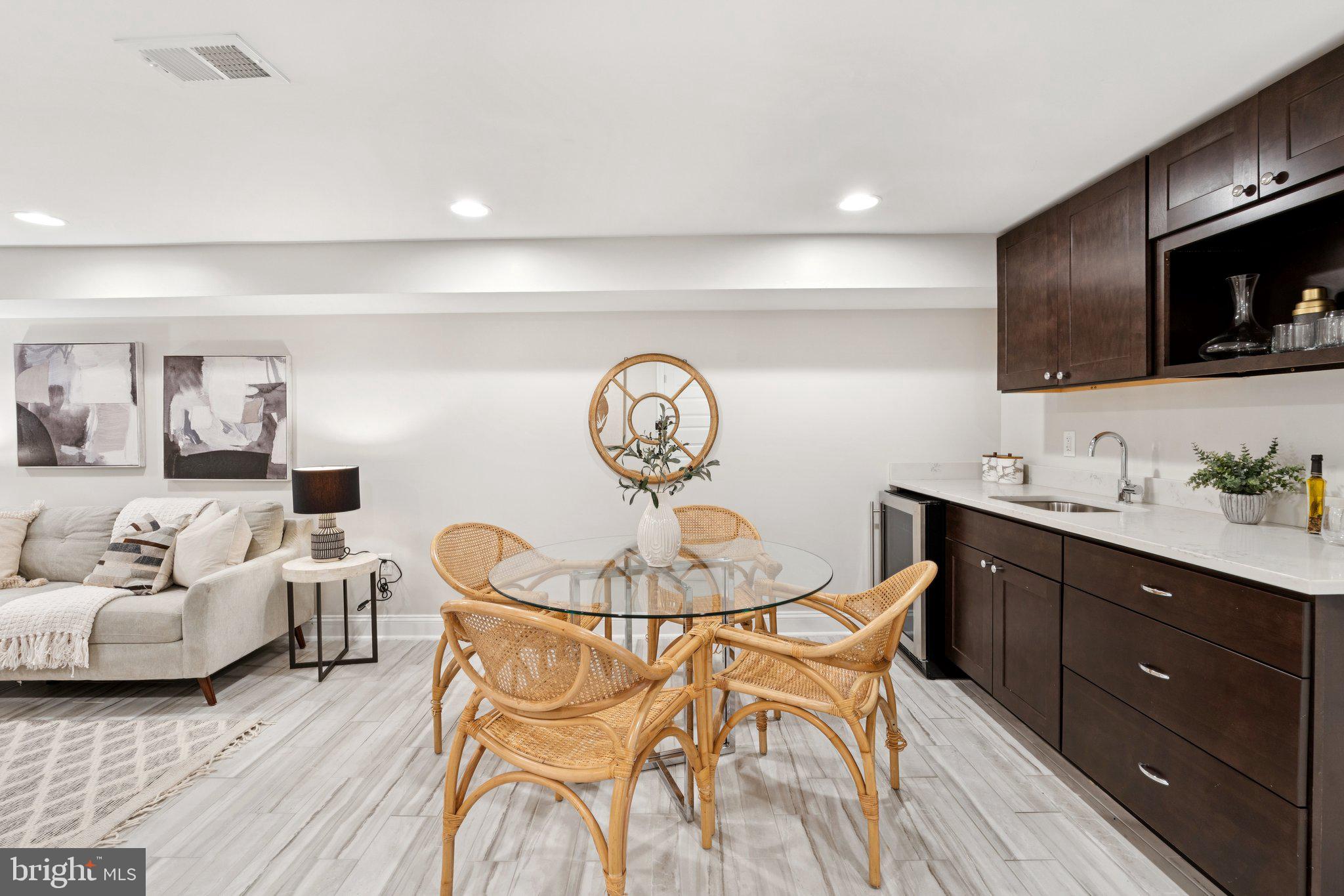 929 Quincy Street Northwest Washington, DC 20011 - Photo 25 of 37 a living room with furniture a flat screen tv and kitchen view