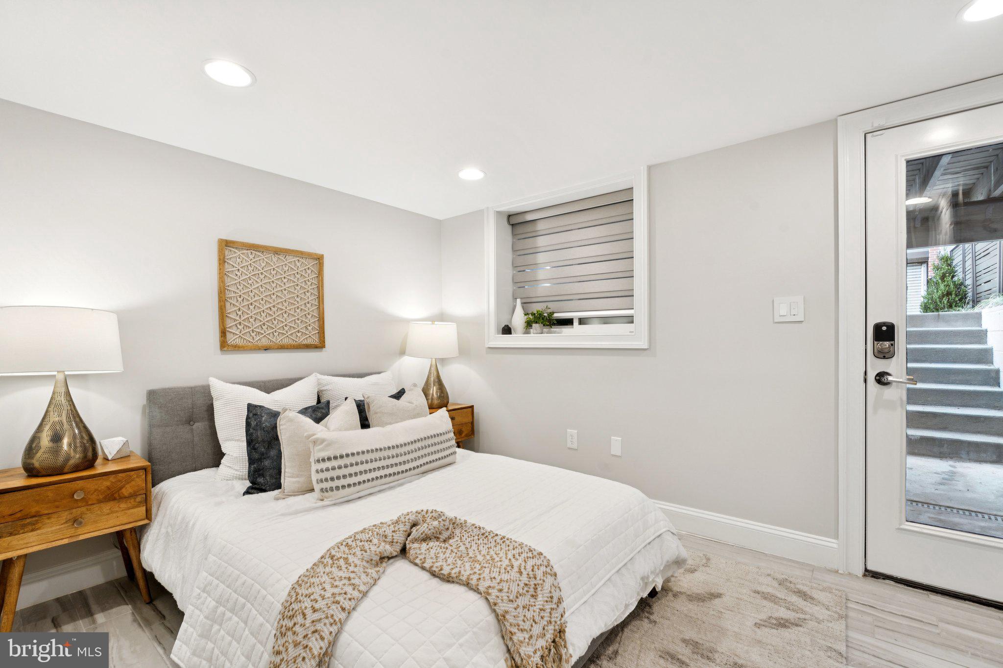 929 Quincy Street Northwest Washington, DC 20011 - Photo 31 of 37 a bedroom with a bed and wooden floor