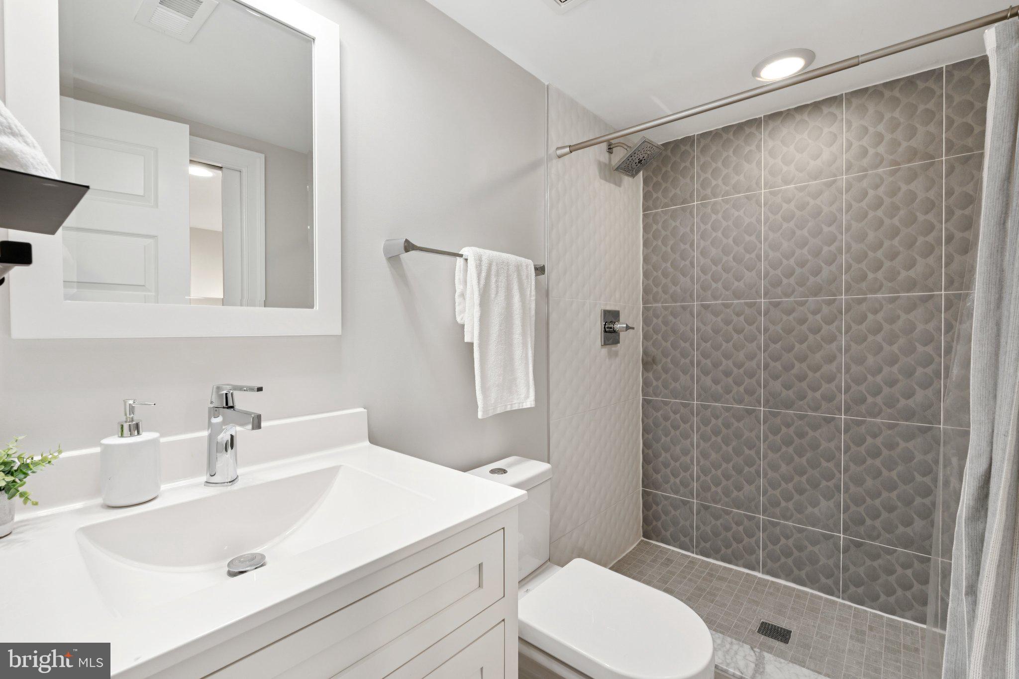 929 Quincy Street Northwest Washington, DC 20011 - Photo 32 of 37 a bathroom with a sink toilet and shower