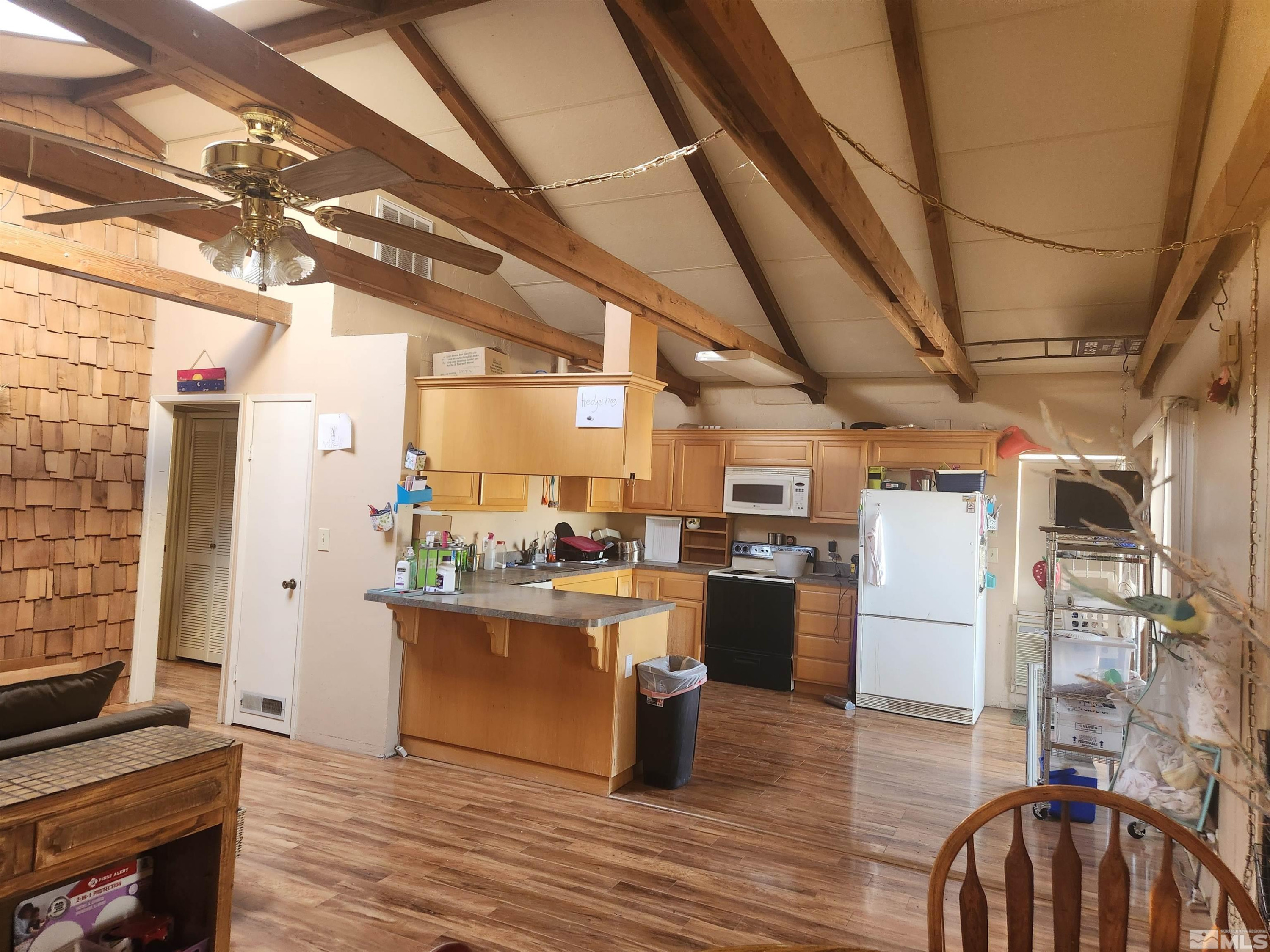 2703 Clapham Lane Minden, NV 89423 - Photo 5 of 6 a kitchen with refrigerator and cabinets