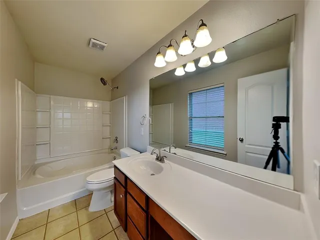 a bathroom with a sink a toilet and a bathtub