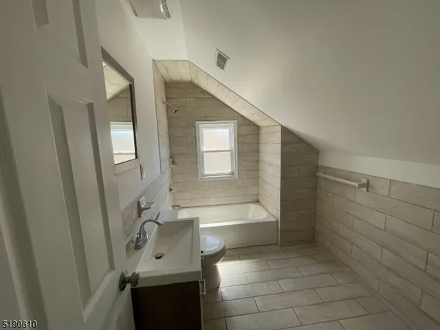 a bathroom with a bathtub sink and toilet