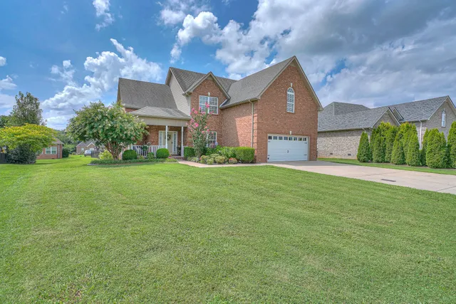 a front view of house with yard and green space