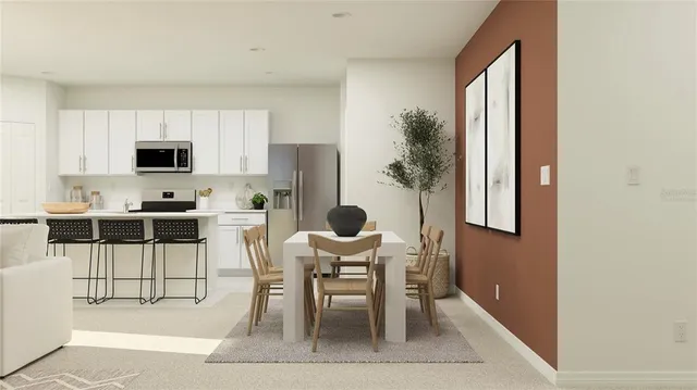 a kitchen with granite countertop a table and chairs in it