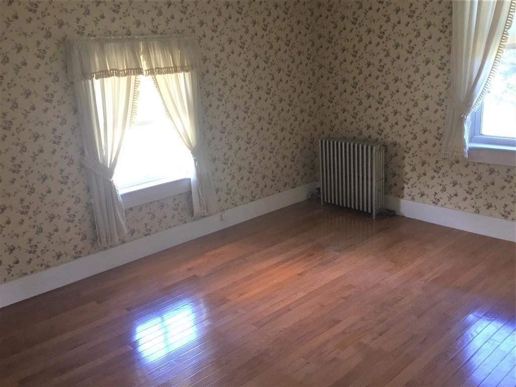 7 Argilla Road Ipswich, MA 01938 - Photo 14 of 20 an empty room with wooden floor and windows