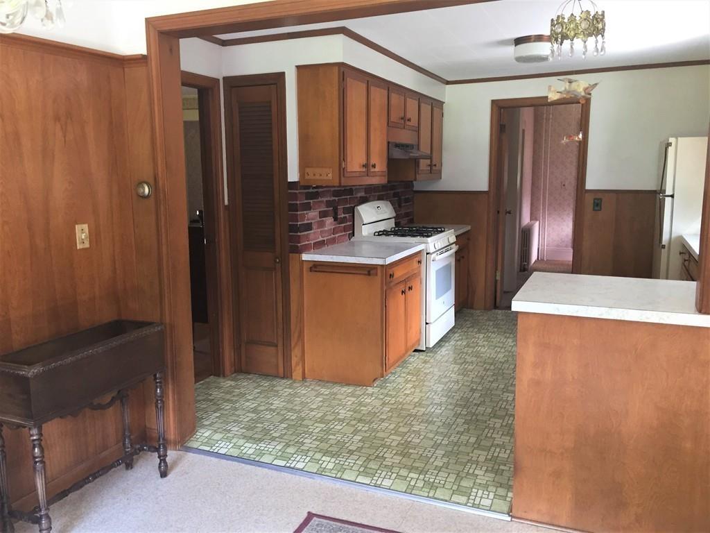 7 Argilla Road Ipswich, MA 01938 - Photo 8 of 20 a kitchen with stainless steel appliances granite countertop a sink stove and refrigerator