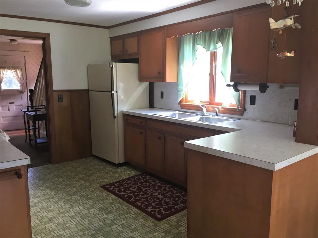 7 Argilla Road Ipswich, MA 01938 - Photo 10 of 20 a kitchen with a sink a stove a refrigerator and cabinets