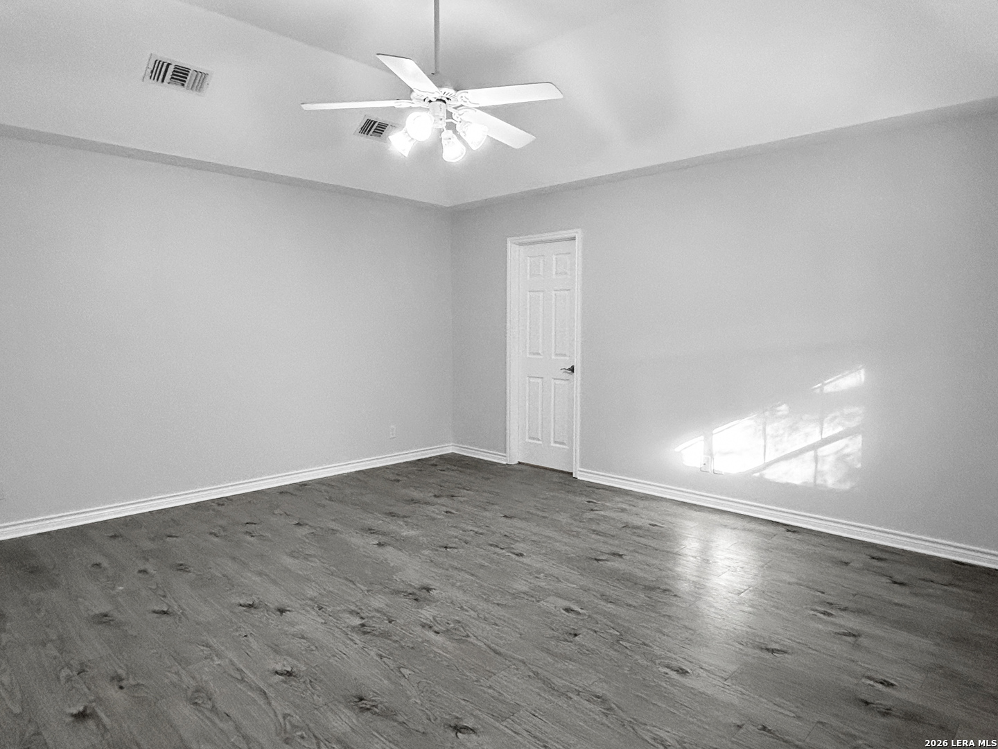 607 Topaz Avenue Seguin, TX 78155 - Photo 13 of 23 an empty room with wooden floor and window