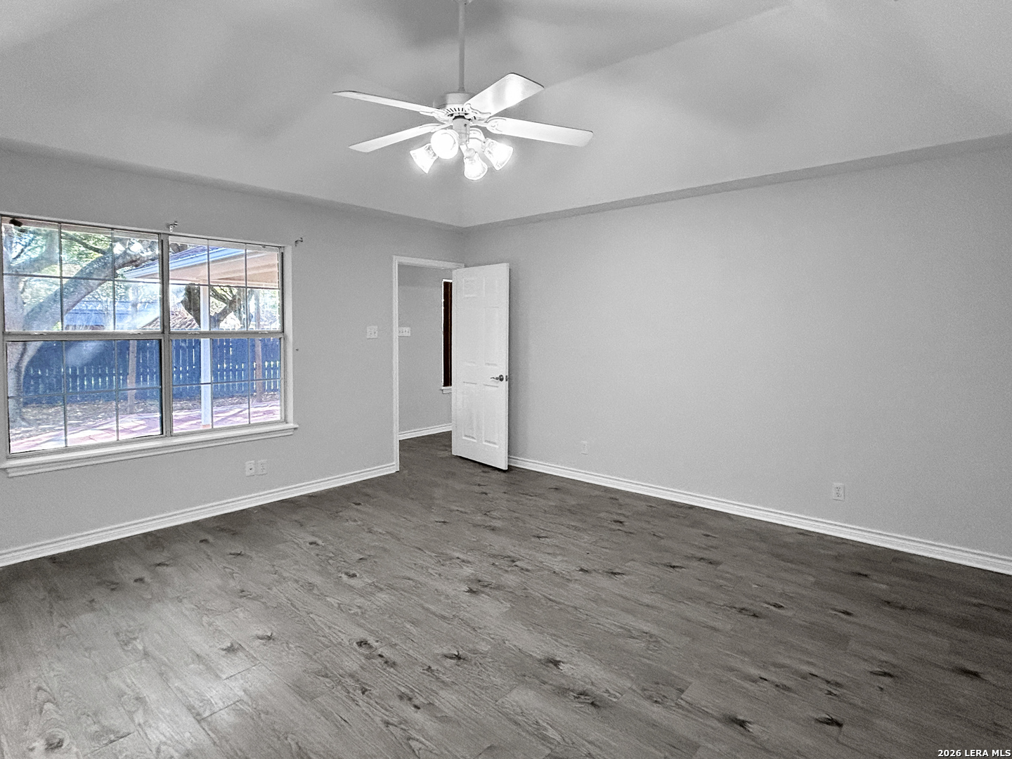 607 Topaz Avenue Seguin, TX 78155 - Photo 14 of 23 an empty room with wooden floor and windows