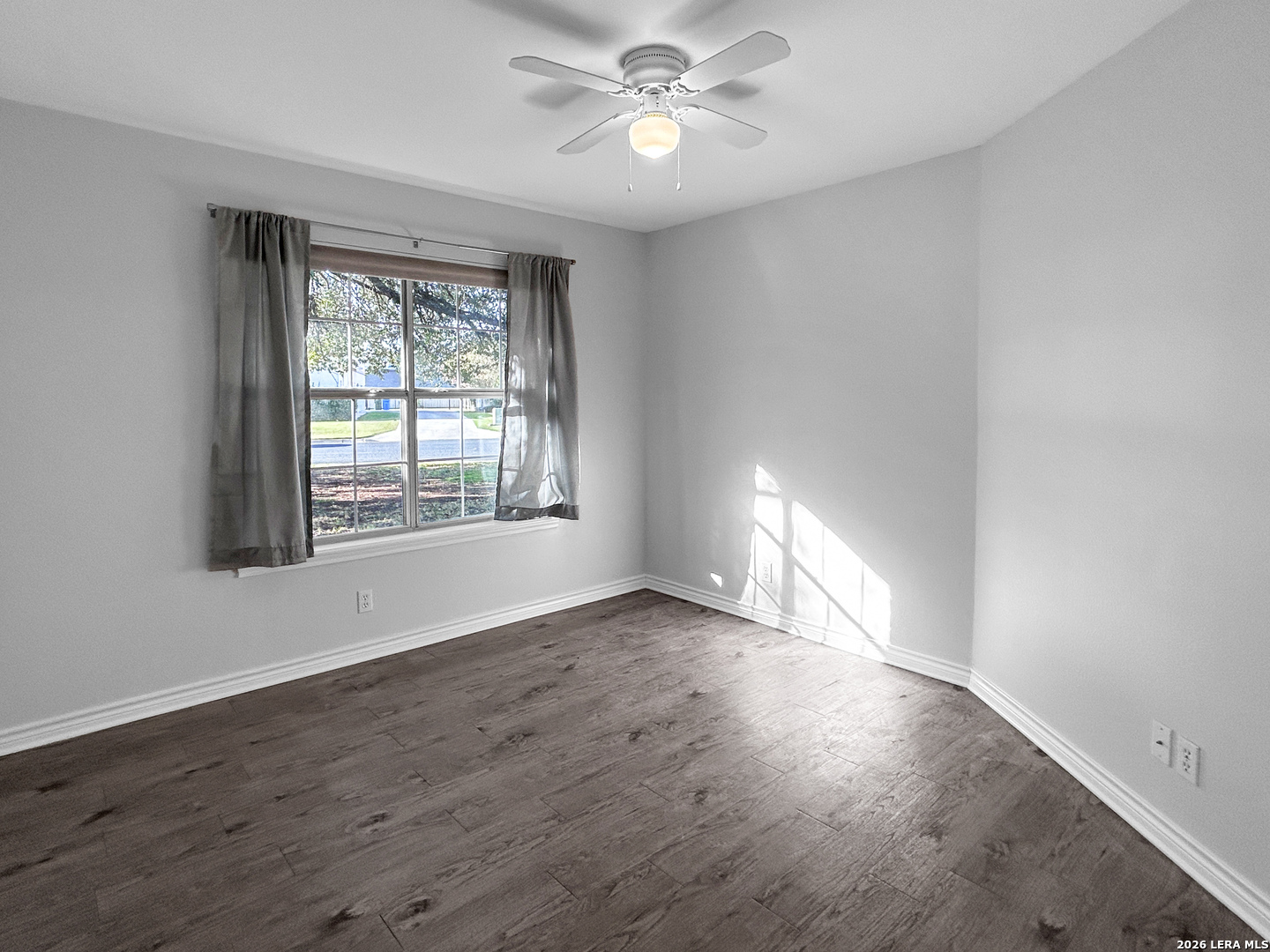 607 Topaz Avenue Seguin, TX 78155 - Photo 18 of 23 an empty room with wooden floor chandelier fan and windows
