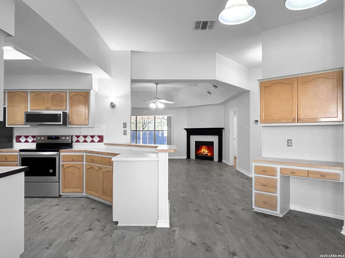 607 Topaz Avenue Seguin, TX 78155 - Photo 10 of 23 a kitchen with a stove and a fireplace