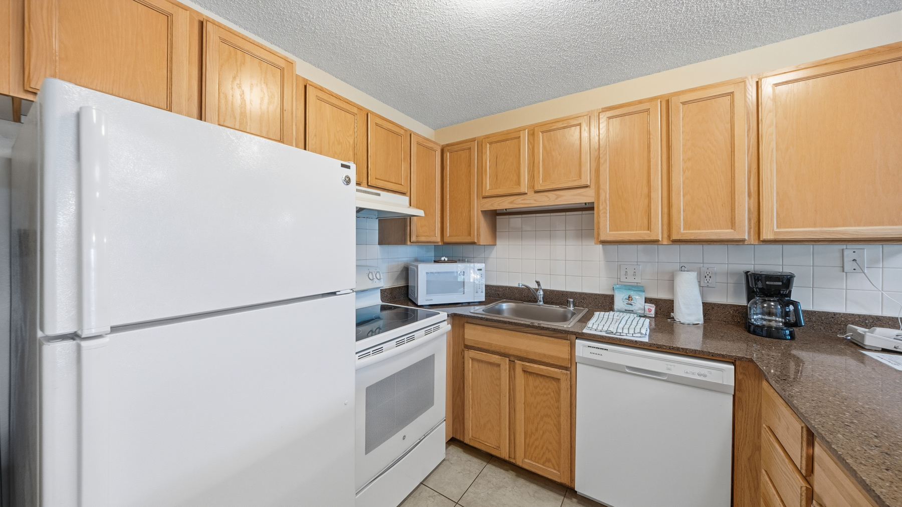 3411 Wilcox Road, Unit CV38 Lihue, HI 96766 - Photo 6 of 16 a kitchen with a refrigerator a sink and cabinets