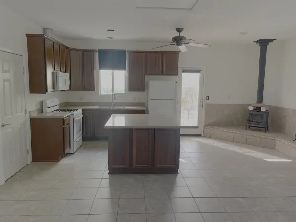 a kitchen with a sink a stove and cabinets