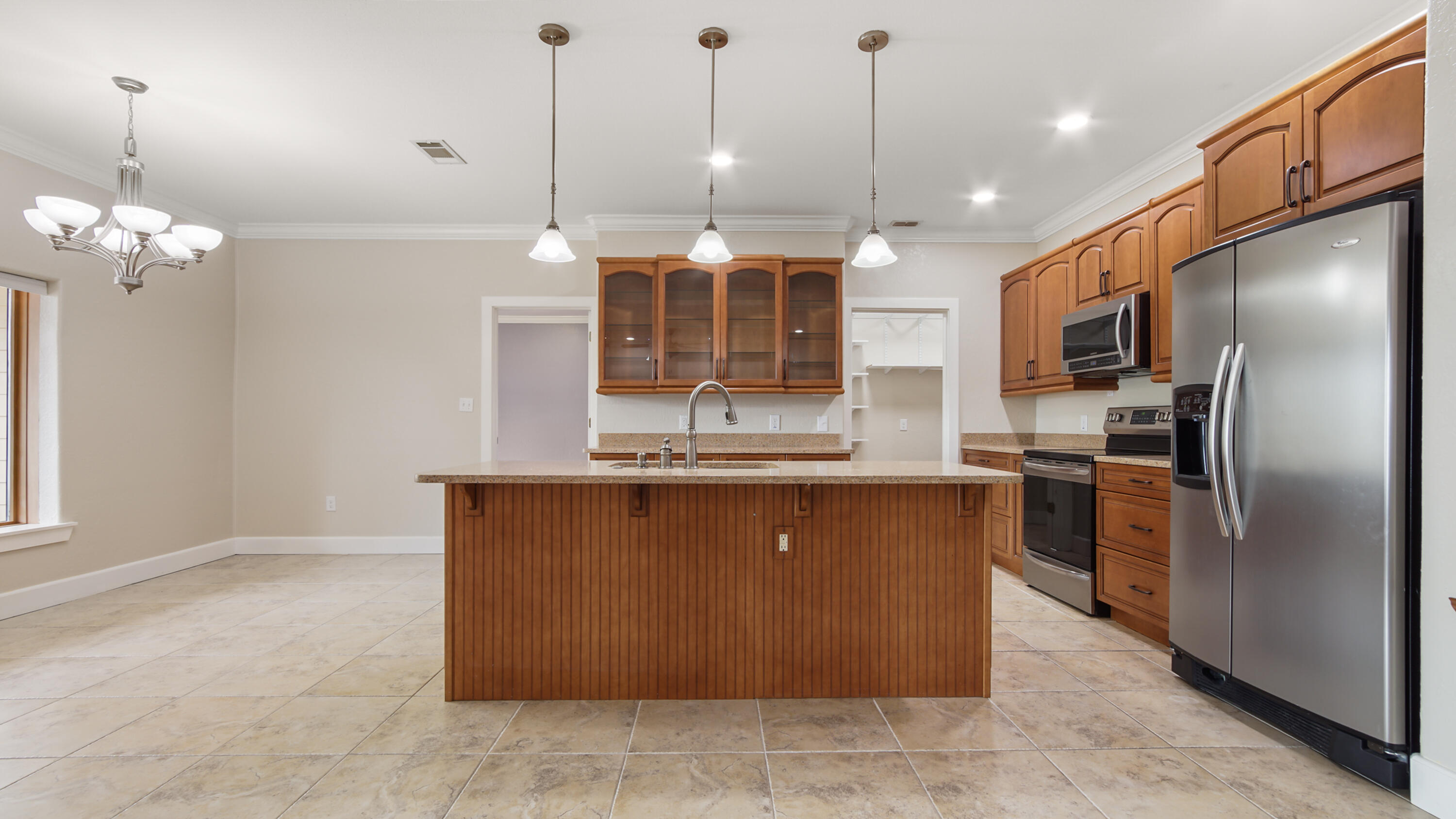 2060 Spring Lake Road DeFuniak Springs, FL 32433 - Photo 19 of 80 a kitchen with kitchen island a counter top space stainless steel appliances and a chandelier