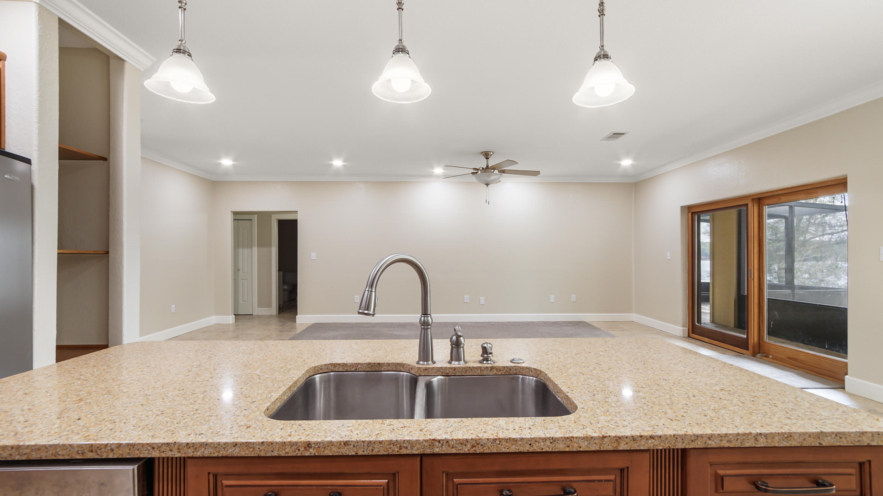 2060 Spring Lake Road DeFuniak Springs, FL 32433 - Photo 24 of 80 a kitchen with a sink a counter space and a refrigerator