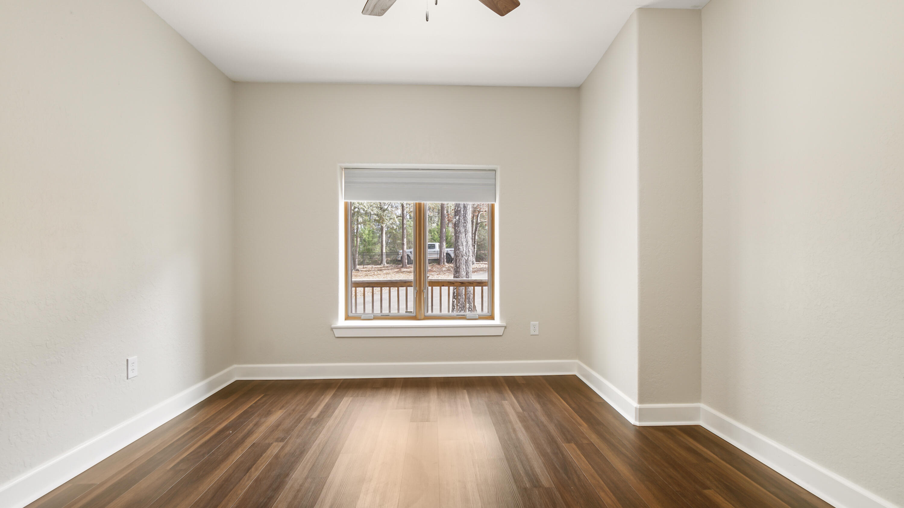 2060 Spring Lake Road DeFuniak Springs, FL 32433 - Photo 10 of 80 an empty room with wooden floor and windows